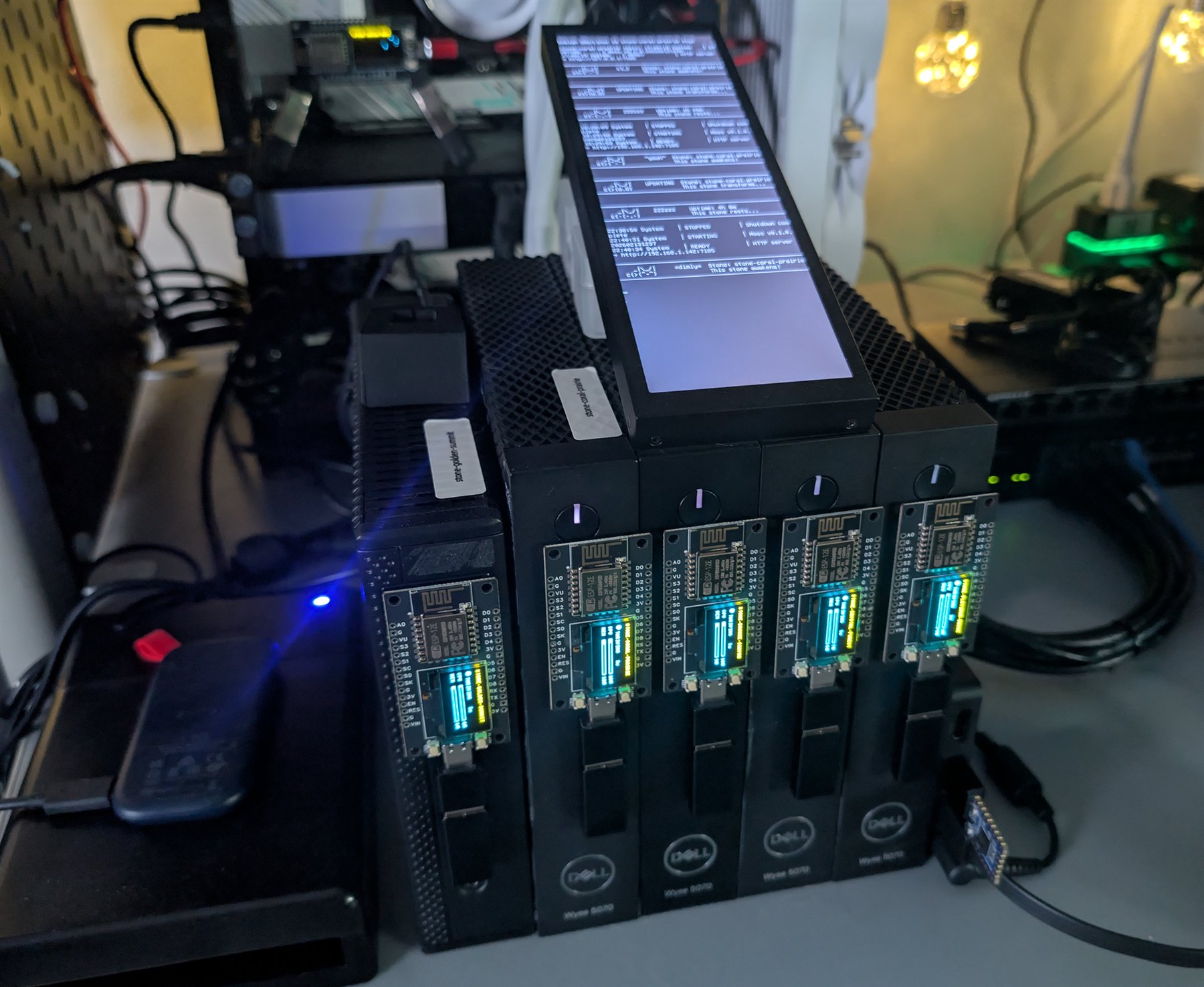 An operational Zen Garden on a workbench, with repurposed Dell thin clients, illuminated companion displays and a central status screen.